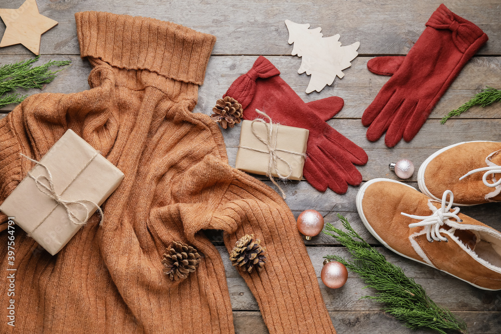 Christmas composition with stylish clothes and accessories on wooden background