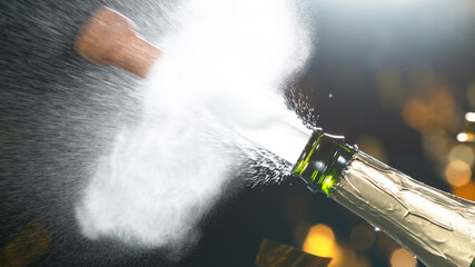 Champagne explosion with flying cork closure, opening champagne bottle closeup, celebration theme.