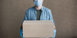 © kite_rin - Delivery man employee wearing face mask and gloves holding cardboard box. Isolated, panoramic banner. Service, business, lockdown, quarantine, pandemic, coronavirus covid-19, shipping, post concept