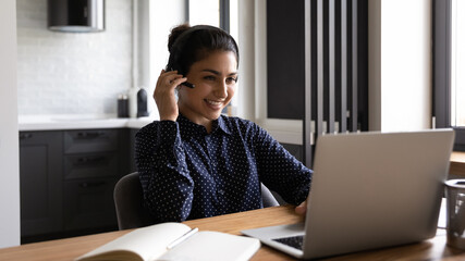 Sticker - Engaged in distant training. Active young indian lady remote worker take part in virtual meeting using home computer. Mixed race female student participate in video conference wearing wireless headset