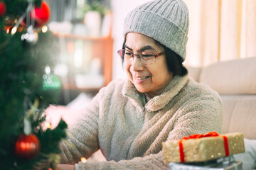 Wall Mural - Happy asian elder woman wellness lifestyle at home alone on Christmas holidays.