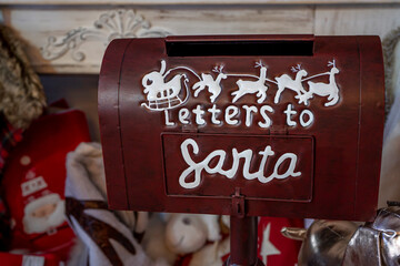 Christmas letter box made out of metal sitting on a wooden counter. Winter holidays, December. High quality photo