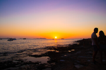 Wall Mural - couple on the beach at sunset