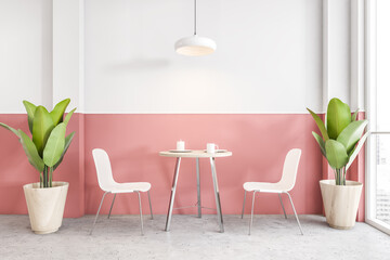 White and pink cafe, two chairs with table with plants near window