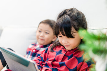 Sticker - Asian kids sibling sister brother video call in christmas holidays celebrate at home.Online video call zoom.Kids watching video with tablet.New normal.Covid-19 coronavirus.Social distancing.stay home.