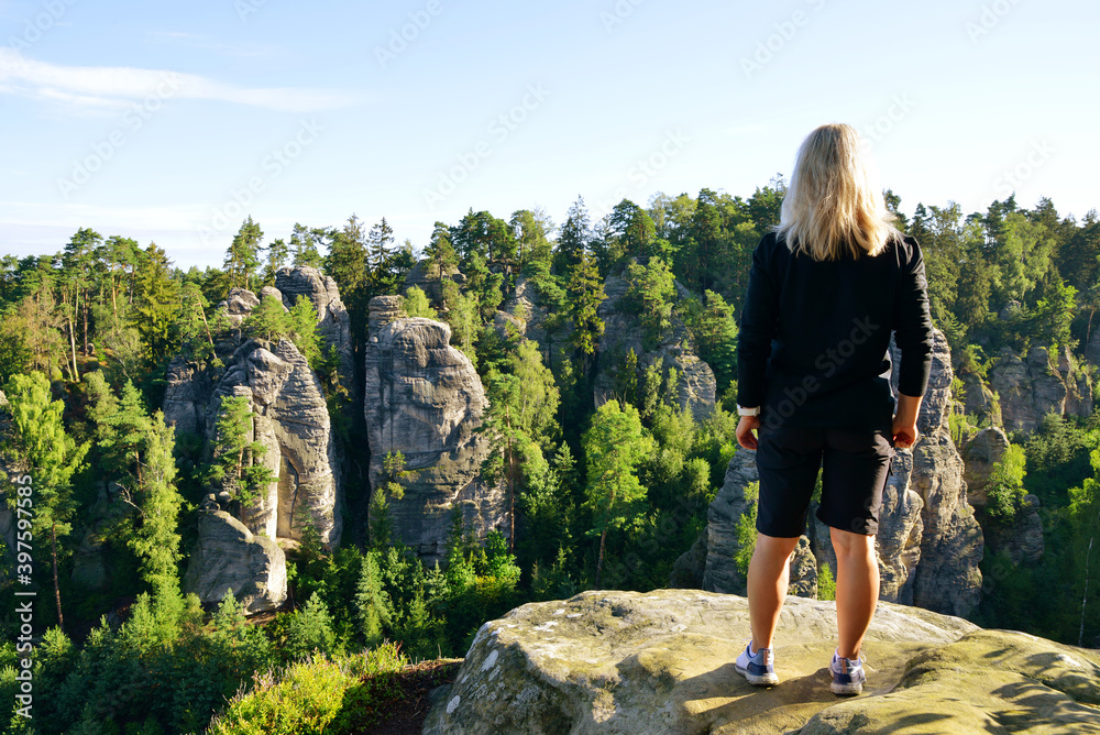 Woman looking at the sandstone rock in Prachovske skaly, Bohemian Paradise (Cesky Raj), Czechia. - obrazy, fototapety, plakaty 