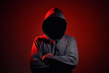 Wall Mural - Silhouette af man without face in hood on red background. Anonymous crime concept