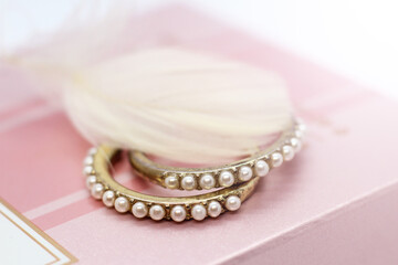 Pearl earrings on a pink box