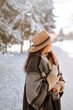 © maxbelchenko - Young woman  enjoying winter weather in the snow forest.  Cold weather. Winter fashion, holidays, rest, travel concept.