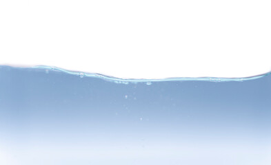 A photograph of a moving water wave with a small amount of bubbles.  Where the water is blue and the backdrop is white