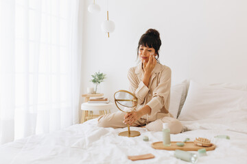 Wall Mural - woman doing self care applying beauty cosmetics