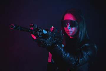 Futuristic girl soldier with a gun in the smoke on the dark background.