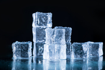 Wall Mural - ice cubes and crushed ice on a black background