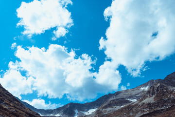 Wall Mural - Blue sky and clouds over the rocks, beautiful cloud landscape over mountain range