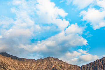 Wall Mural - Blue sky and clouds over the rocks, beautiful cloud landscape over mountain range