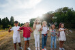 © Andrii - A large group of cheerful children play in the Park and inflate soap bubbles. Games in a children's camp