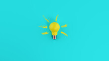 Yellow Lightbulb On Cyan Background. Concept Of Creativity And Idea