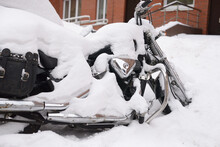 Winter In Russia. Abandoned Motorcycle Covered With A Thick Layer Of Snow