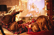 © JenkoAtaman - family mother father and children watching projector, film, movies with popcorn in   christmas evening   at home.