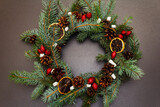 Fototapeta Na drzwi - Zero waste Christmas wreath with fir tree branches, rosehip berries, lemon slices and marshmallows
