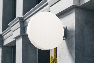 Wall Mural - Blank white wooden round banner on building wall.