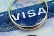 Macro photo of US entry visa sticker in a passport and a ring. Conceptual photo for fiancee visa and immigration. Selective focus.
