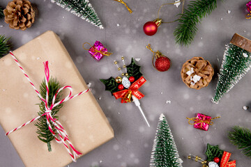 Canvas Print - Christmas holiday composition with gift box and snow decoration, new year and xmas or anniversary with presents on cement floor background in season, top view or flat lay, copy space.