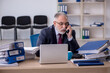 © Elnur - Aged male employee unhappy with excessive work