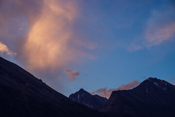 Wall Mural - amazing vivid landscape of sunset with silhouettes of rocky mountains and glow orange clouds. atmosp