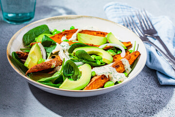 Canvas Print - Vegan food concept. Baked sweet potato salad with avocado and edamame.