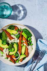 Canvas Print - Vegan food concept. Baked sweet potato salad with avocado and edamame, top view.