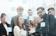 © ASDF - Manager pointing to a glass Board with sticky notes