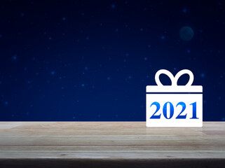 Gift box happy new year 2021 flat icon on wooden table over fantasy night sky and moon, Business shop online concept