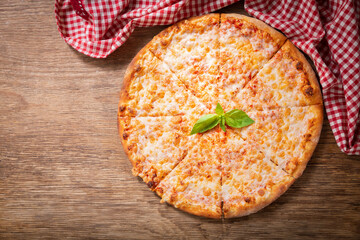 Poster - pizza margherita on a wooden background