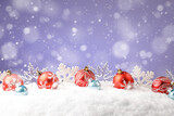 Fototapeta Do pokoju - Christmas red balls with snowflakes on purple background