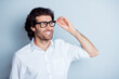 © deagreez - Photo portrait of dreamy man looking far holding glasses in hand isolated on clear white colored background
