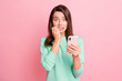 © deagreez - Photo of worried girl hold telephone gnaw bite fingernails look camera wear turquoise sweater isolated pink color background