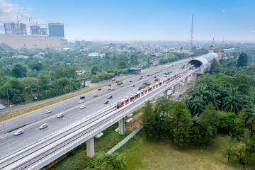 Wall Mural - Aerial view of LRT train next to a tollway