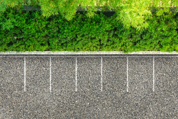 Wall Mural - Empty space parking lot on asphalt road nearly green bush and trees from aerial view.