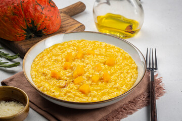 Poster - Pumpkin risotto on white table. Close-up. Ingredients on background.