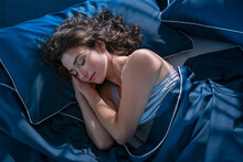 Young Woman Sleeping Profoundly At Night