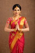 © krishna - Beautiful smiling Indian bride welcoming on white