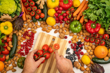 Wall Mural - A cook who is cutting vegetables on a white wooden table