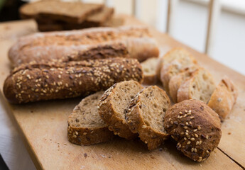 Wall Mural - fresh loaf of bread on wooden board