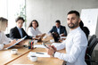 © Prostock-studio - Arab Businessman At Business Meeting Sitting At Desk In Office