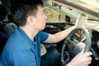 © Recycle Man - Asian men use mobile phones to find their way with a map GPS navigator.