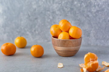 Wall Mural - Fresh whole clementine fruits on neutral background