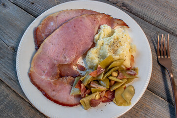 Wall Mural - rustic Thanksgiving plate of baked ham with mash potatoes and green beans flat lay