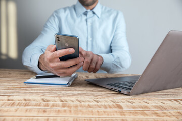 Poster - man holding phone in working table