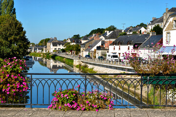Wall Mural - River Oust seen from bridge, part of canal Nantes at Brest, and flowers at Josselin, a commune in the Morbihan department in Brittany in north-western France